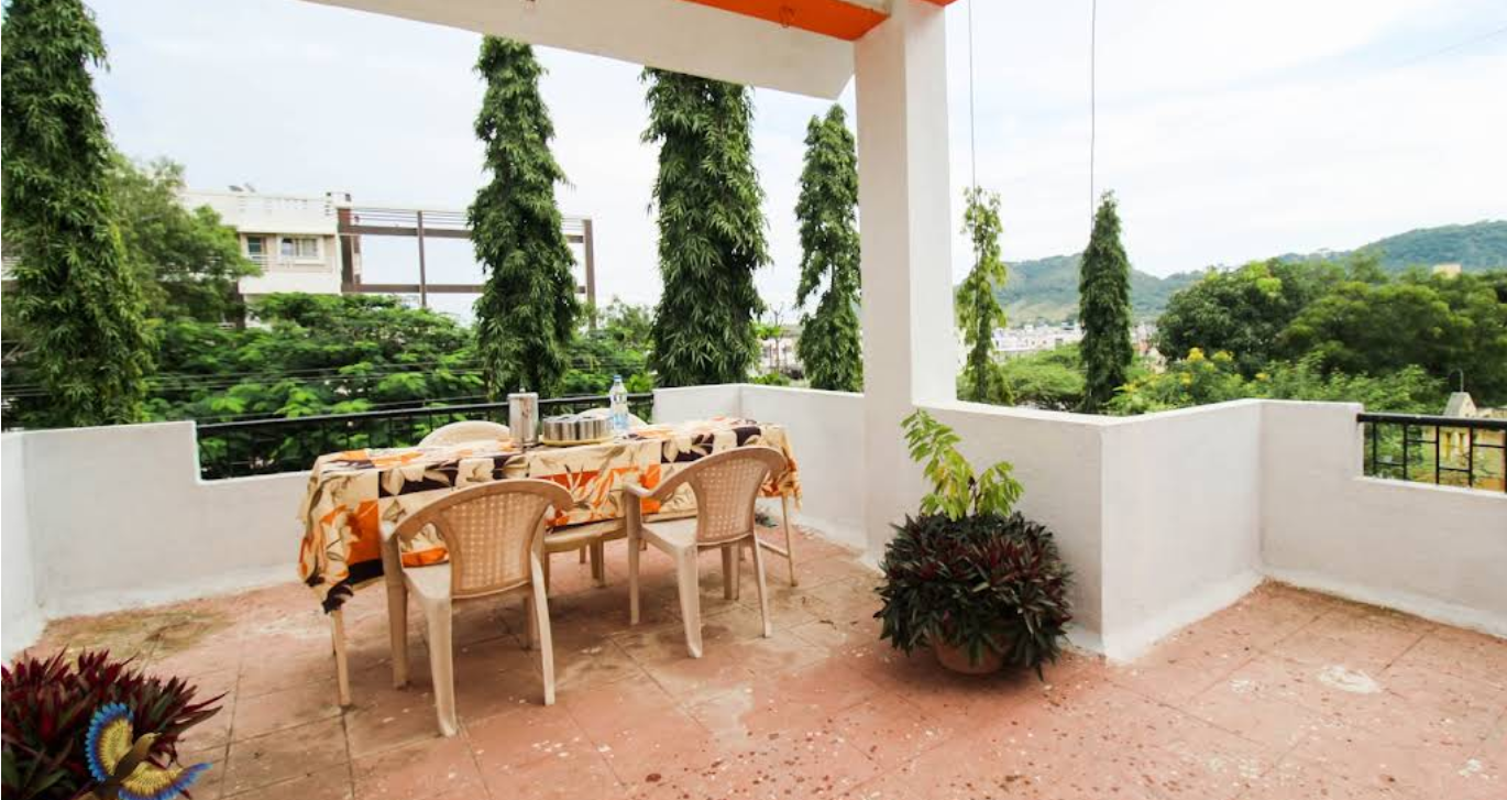 Standard room interior with bed, furniture, and window offering natural light